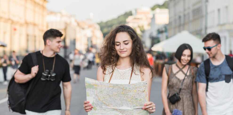 woman-with-map-walking-with-friends-street_23-2147846932